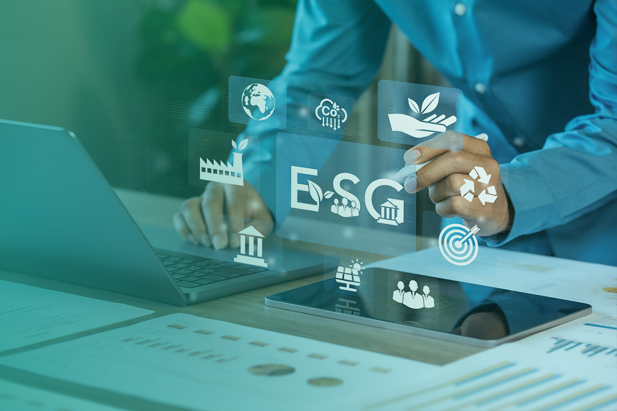 “Professional analysing data on a laptop with digital icons representing Environmental, Social and corporate governance (ESG) performance and sustainability metrics.”