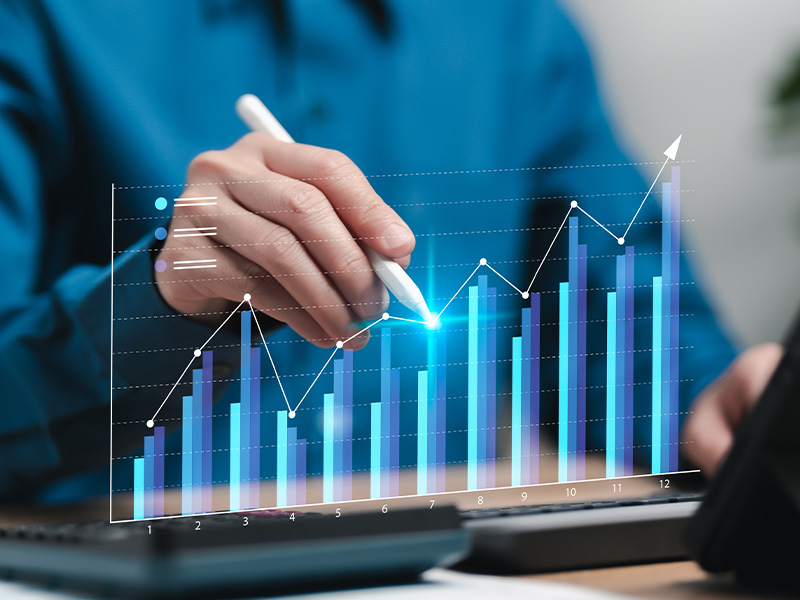 Person using a digital pen to analyse bar and line graphs, illustrating the performance and cost advantages of basket energy procurement over traditional models.