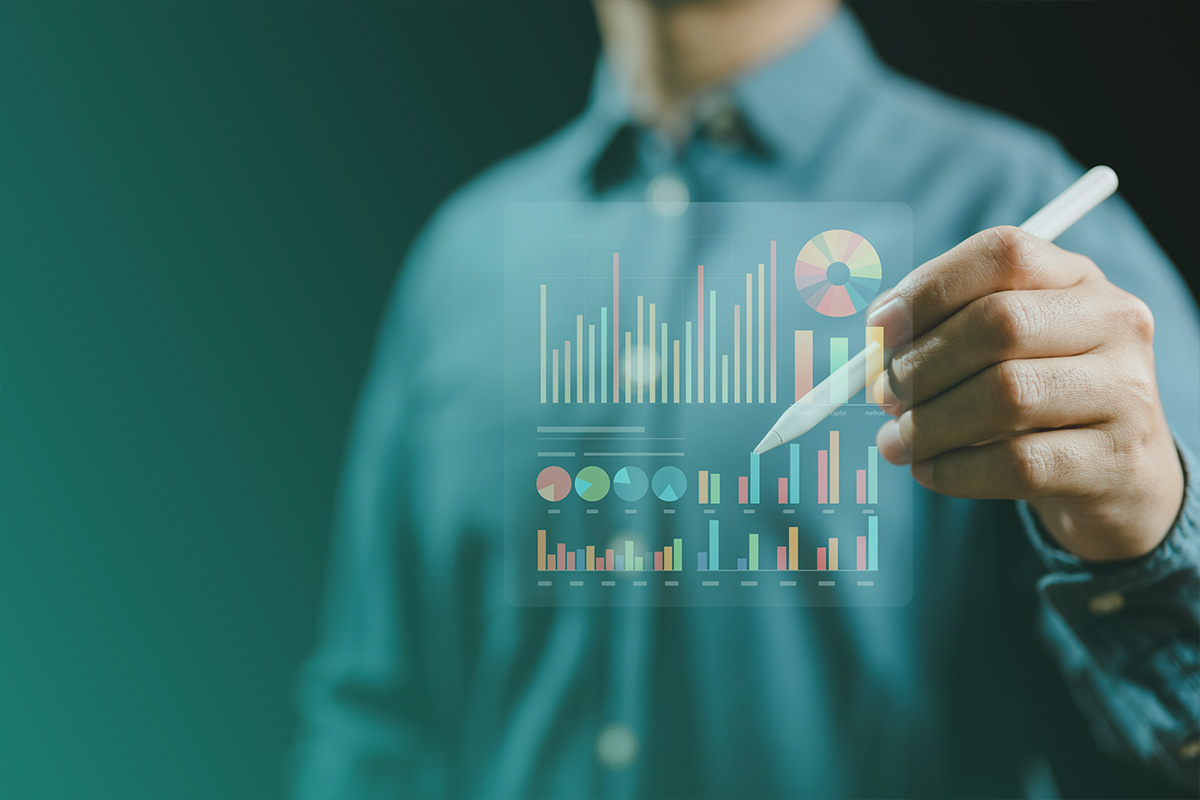 “Person analysing digital charts and graphs on a transparent screen as part of Data Measurement, Reporting and Monitoring processes.”