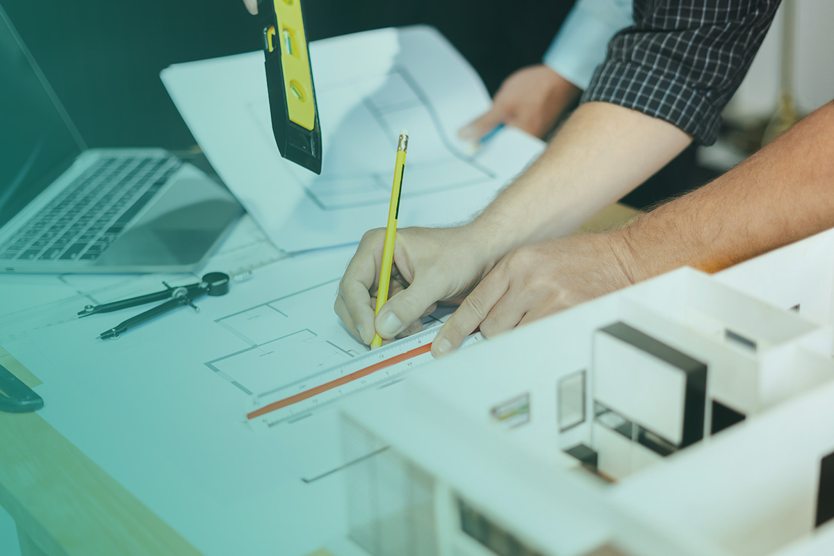 “Engineers reviewing building plans as part of Design and Project Management for Retrofit and Green Specification.”