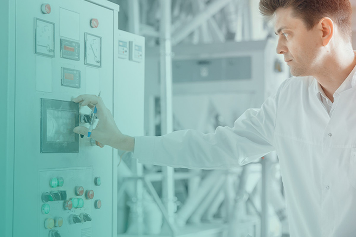 “Engineer operating industrial control panel during an investment grade energy audit to assess system efficiency and performance.”
