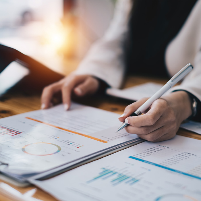 Close-up of a person analysing graphs and charts during an Energy audit process.