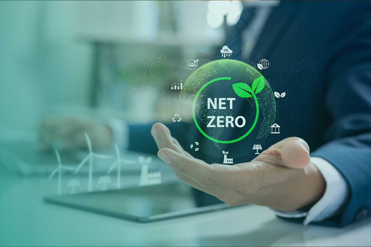 “Business professional holding a digital Net Zero graphic representing sustainability, clean energy, and the Net Zero Transition and Beyond.”