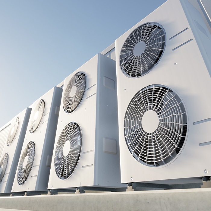 Row of outdoor AC condenser units requiring tm44 inspection for energy compliance.