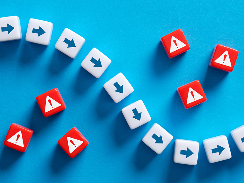 White and red blocks with arrows and warning signs, symbolising the risks and controls managed within basket energy procurement.