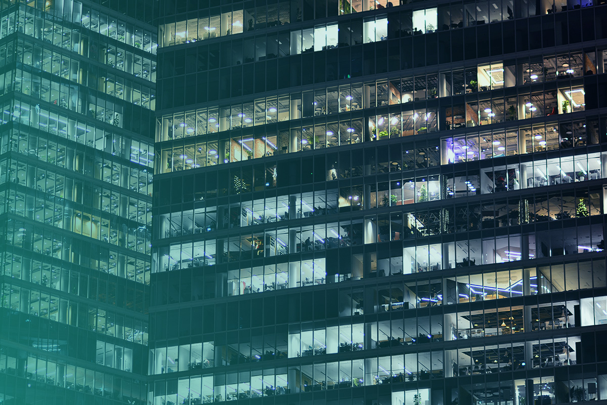 “Night-time view of a multi-tenant office building illustrating energy use patterns relevant to Tenant Recharging and Billing.”