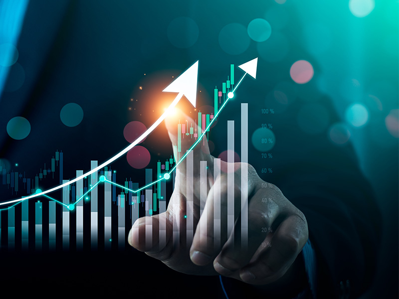 Hand pointing at a rising graph with arrows, symbolising growth driven by energy market intelligence for procurement.