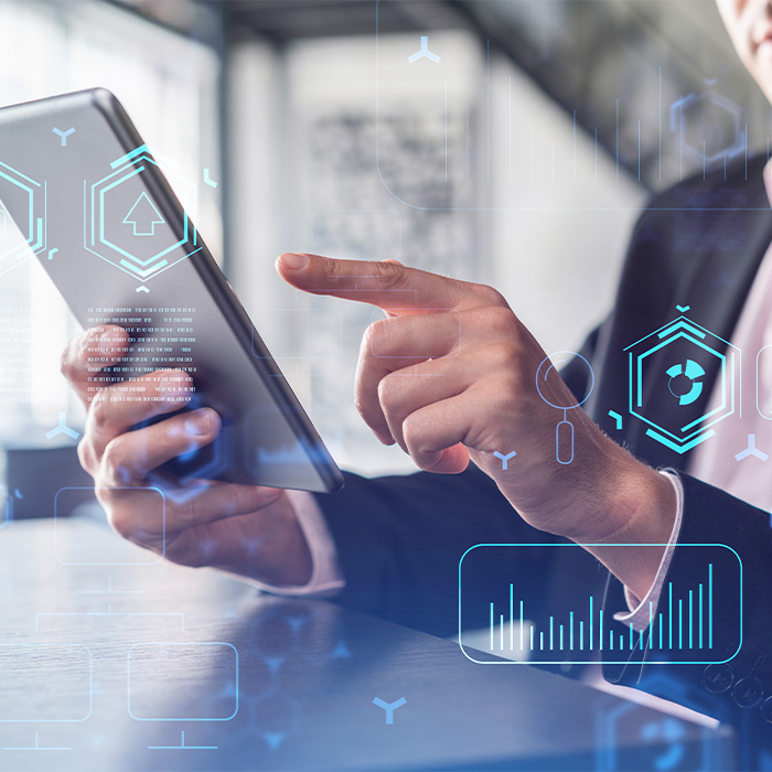 Business professional reviewing data on a tablet as part of an Investment Grade Energy audit.