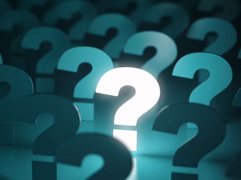 Glowing question mark among many others, symbolising why businesses should choose expert support for AMR energy meters and BMS audits.