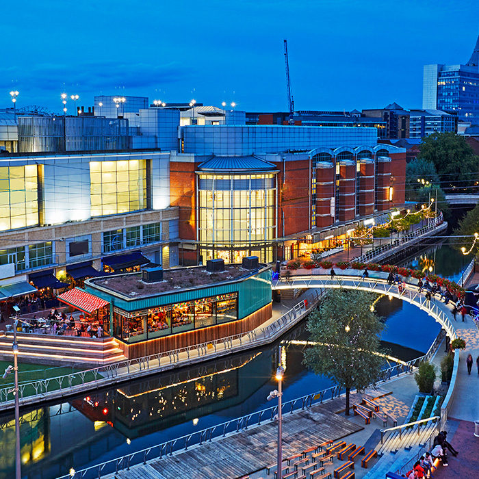 Modern shopping and leisure complex at dusk, reflecting the type of property optimised by energy management specialists.
