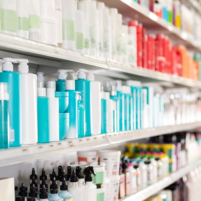 Retail store shelves stocked with brightly coloured bottles, representing energy use supported by business electricity providers.