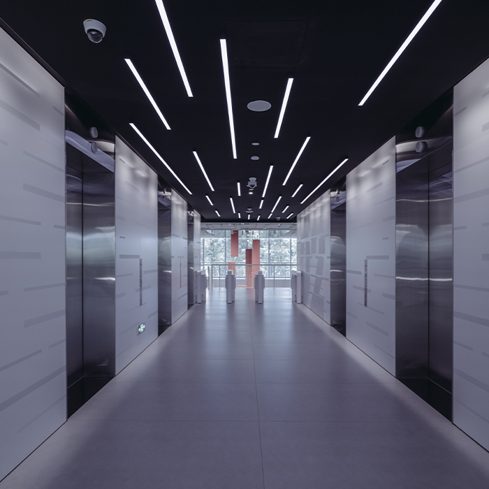 Modern commercial building corridor with energy-efficient LED lighting — a common MEES upgrade measure.