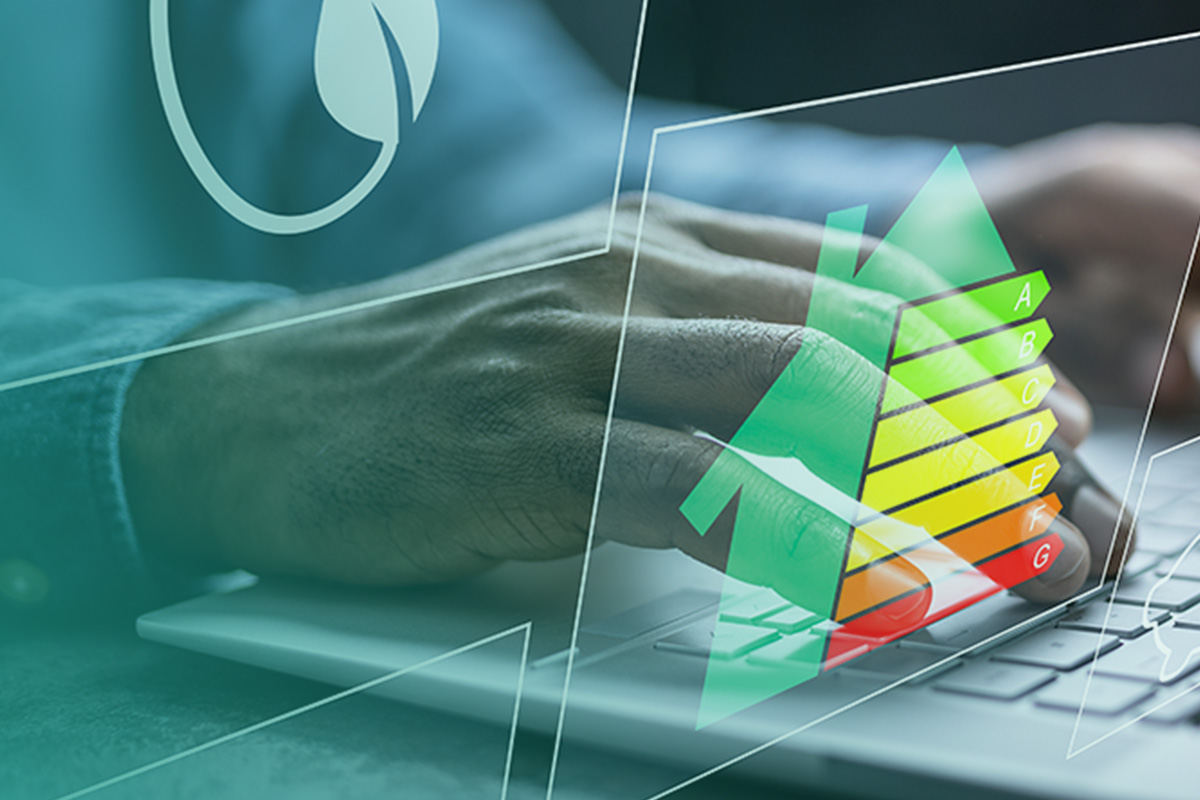 “Hand typing on a laptop with an illustrated energy rating scale, representing EPC – Energy Performance Certificates for Commercial Properties.”