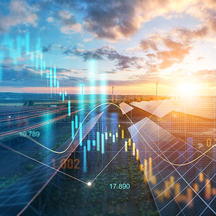Solar panels and wind turbines at sunrise with overlaid data visualisations, symbolising energy monitoring through AMR metering.