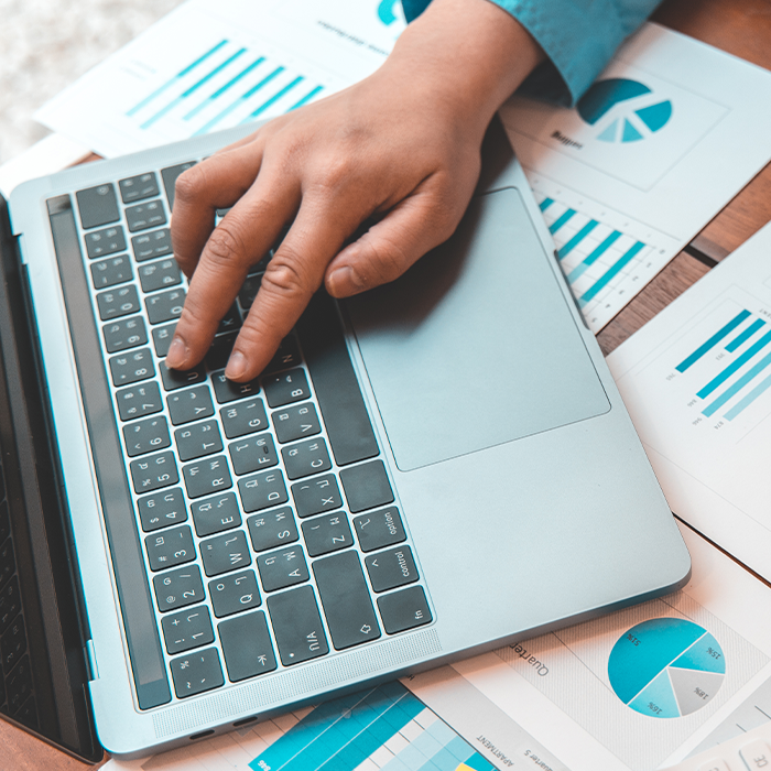 Person analysing business energy data on a laptop, reviewing charts and graphs relevant to ESOS compliance.