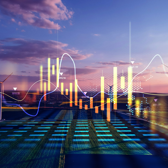 Digital energy data overlays a renewable energy landscape at sunset, representing the dynamic nature of Flexible Energy Procurement.