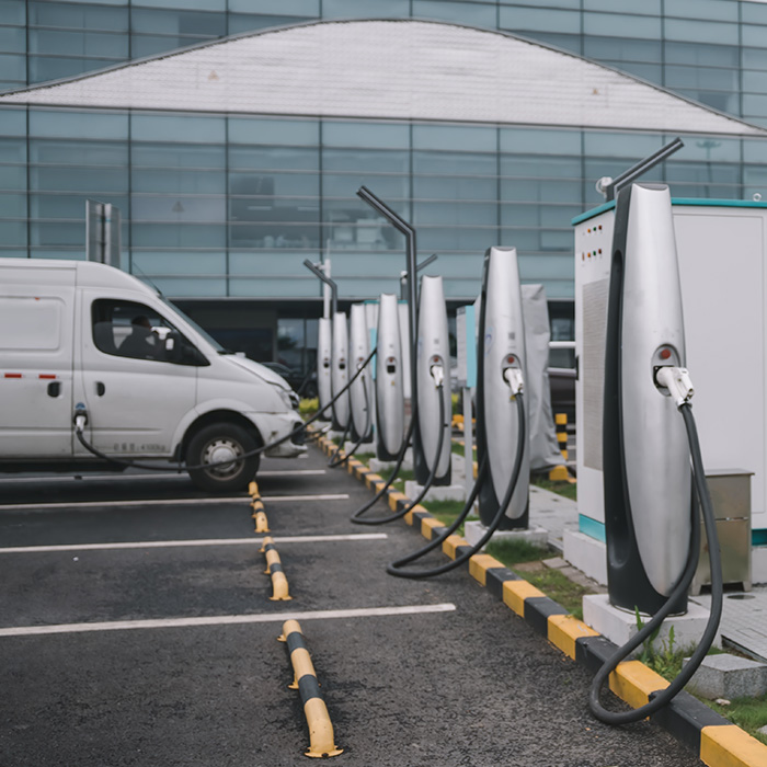 Electric van charging at a commercial EV station, symbolising Hybrid Energy Procurement – Combining the Best of Both.