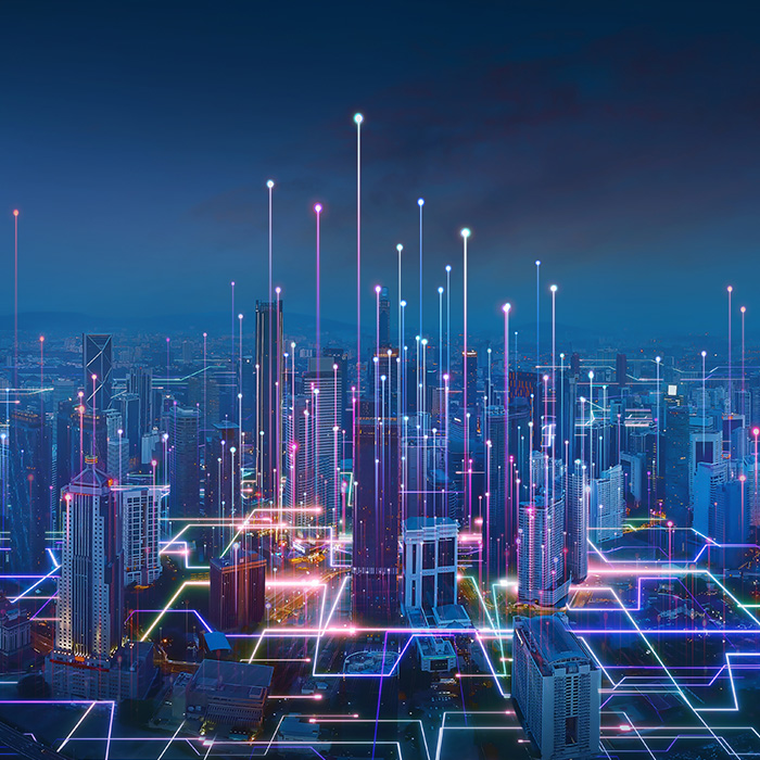 A digitally enhanced city skyline at night, symbolising connectivity and tailored energy solutions across all sectors and scales.