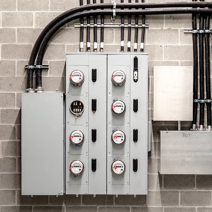 An electrical meter panel system mounted on a wall, representing infrastructure for Fixed vs Flexible Business Energy Procurement.
