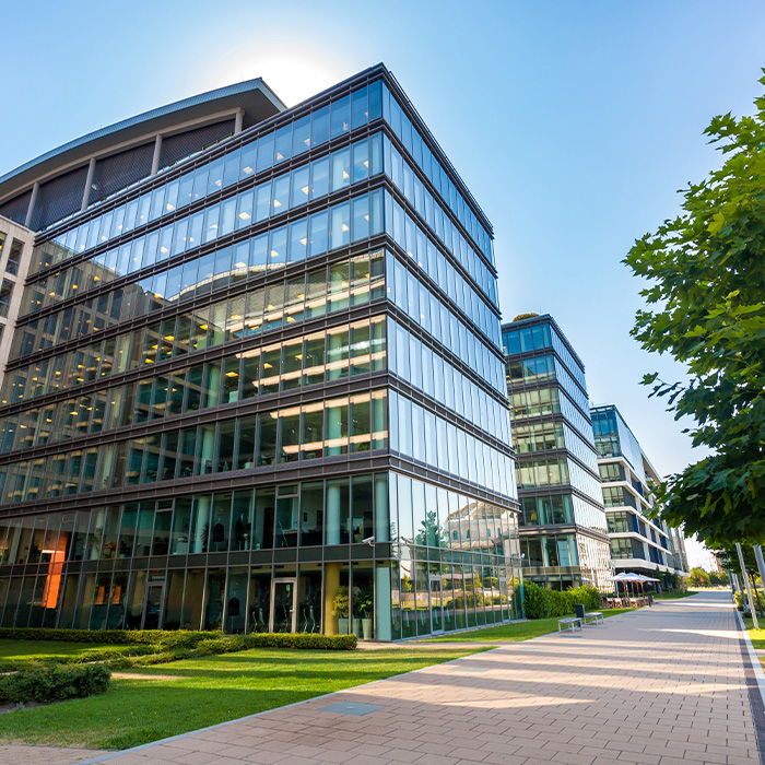 Modern office buildings supported by net zero procurement strategies to reduce environmental impact.