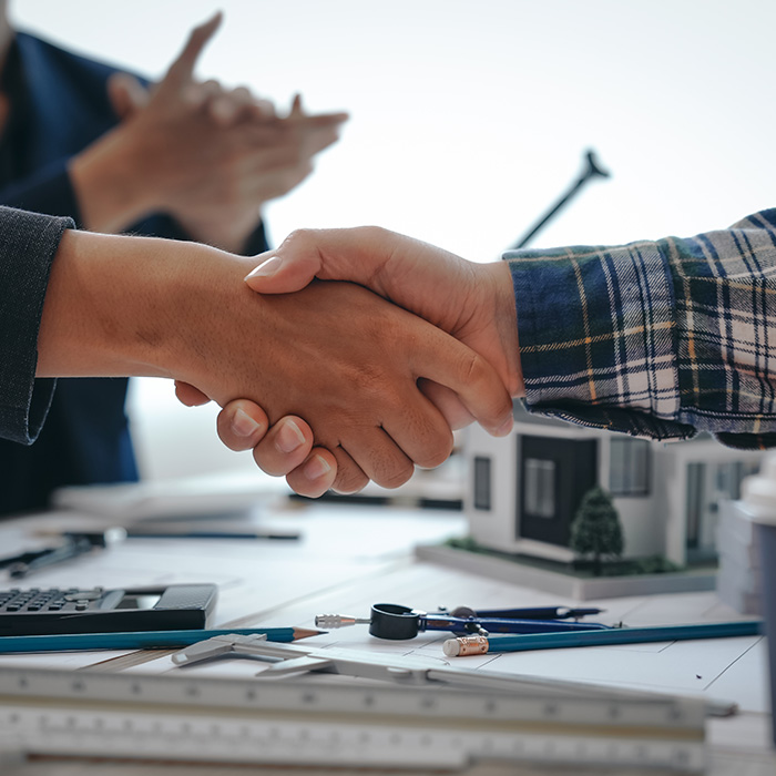 Close-up of a professional handshake in an office setting, symbolising a successful partnership in energy procurement.