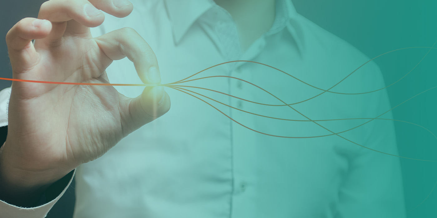 Close-up of a person’s hand drawing converging lines, symbolising alignment in an energy procurement strategy.