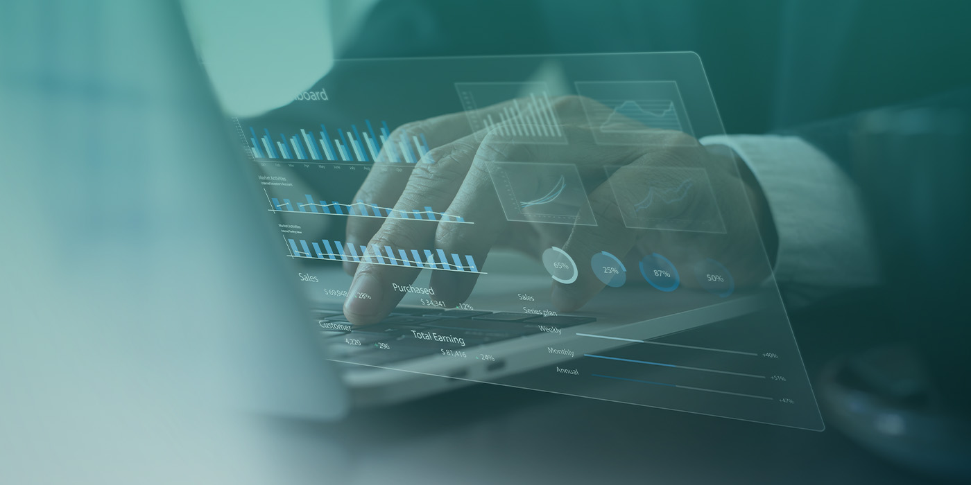 Close-up of hands analysing graphs on a laptop as part of an ongoing energy procurement strategy review.