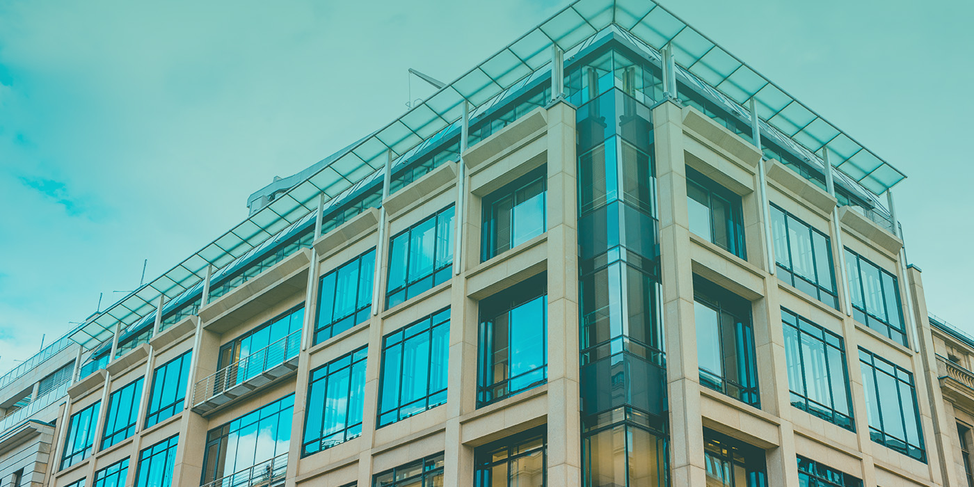 Modern commercial building exterior with glass windows representing upgrades needed for EPC compliance 2027.