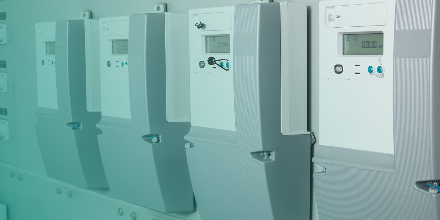 A row of digital energy meters showing accurate readings, highlighting the Smart Metering Toolkit for Landlords & Developers and its role in modern energy management.
