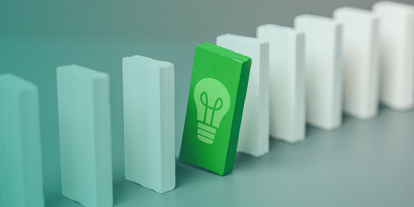 Green energy concept with a single upright green block showing a lightbulb icon, symbolising innovation and resilience in an Energy Procurement Strategy 2026.