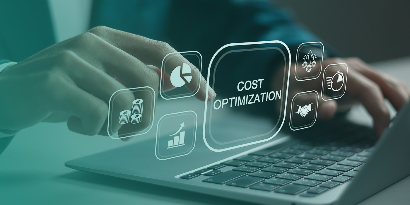 Hands typing on a laptop with digital cost-optimisation icons displayed on screen, illustrating how Energy Data Accuracy supports better financial decisions.