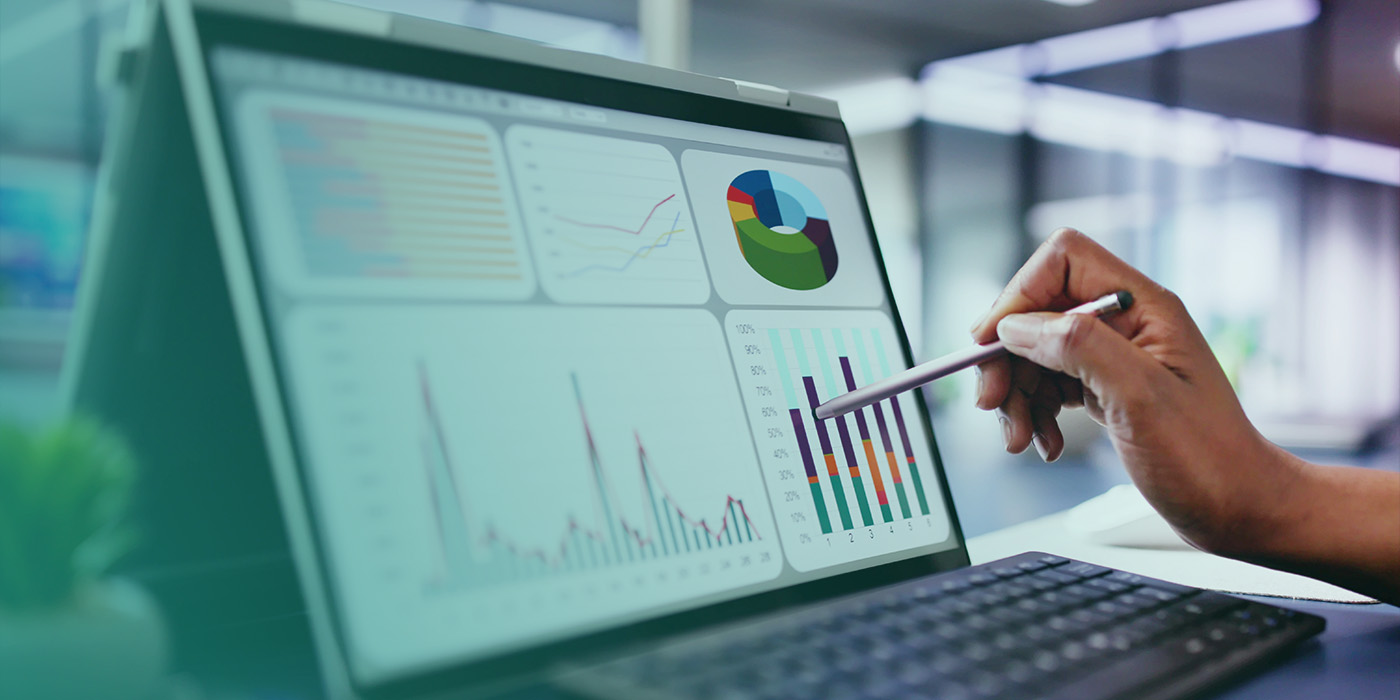 A person analysing charts and graphs on a laptop screen, highlighting the importance of Energy Data Accuracy for clear and reliable reporting.