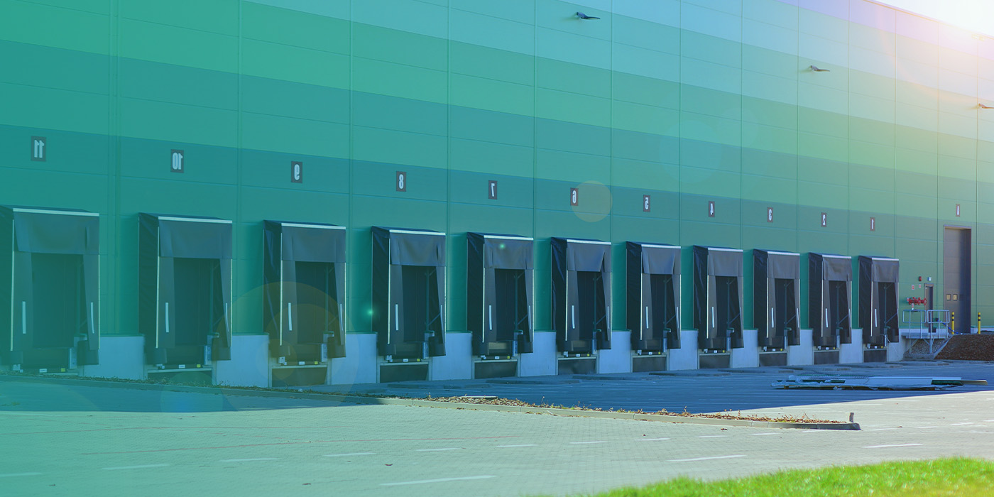 Distribution and logistics centre with multiple loading bays, illustrating how BMS Optimisation supports efficient operations, energy control, and environmental management across large industrial sites.