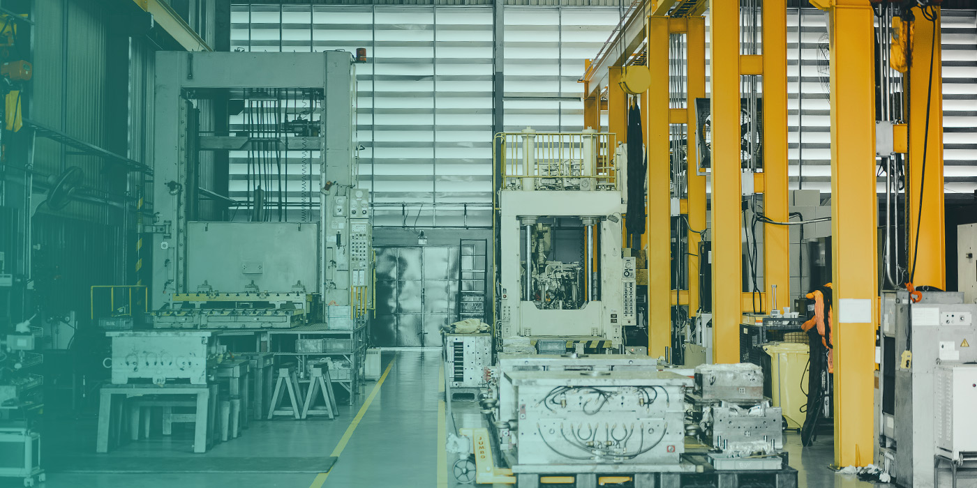 Manufacturing facility with heavy machinery and industrial equipment, showing how BMS Optimisation improves energy efficiency, environmental control, and operational performance in complex production environments.