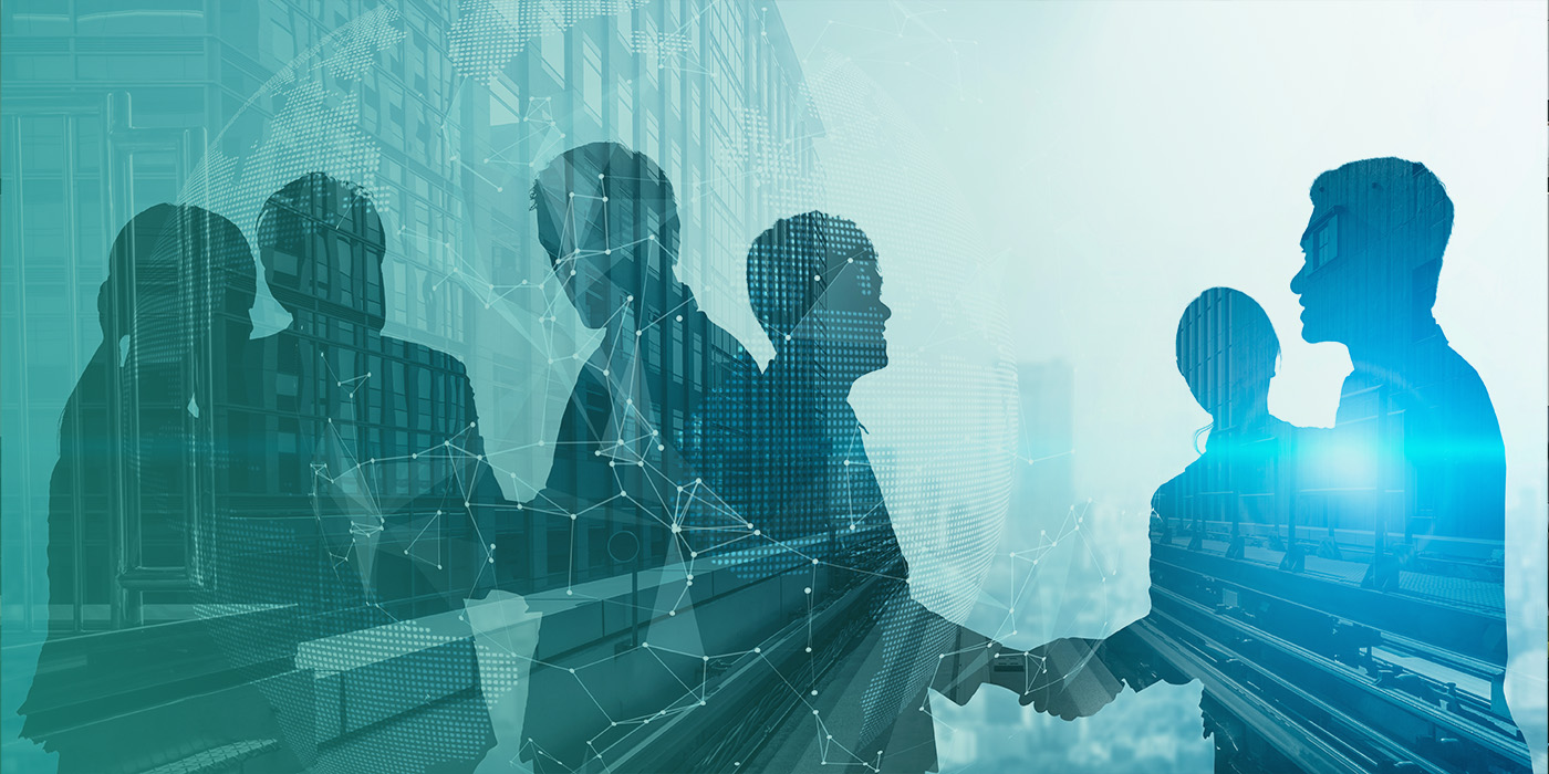 Silhouettes of professionals meeting and shaking hands against a backdrop of modern buildings, representing collaboration on a BMS Optimisation Checklist for improved building performance.