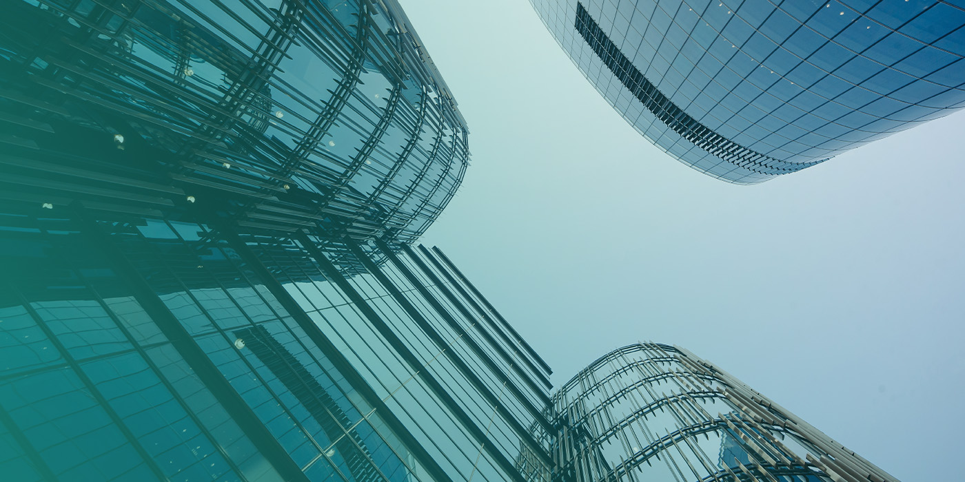 Modern commercial office buildings representing a portfolio where organisations aim to reduce energy costs on fixed contracts through improved visibility and control.