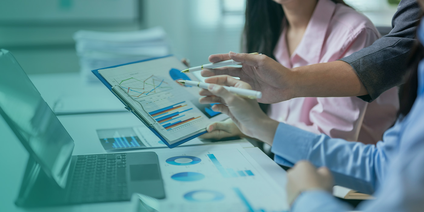 Team reviewing energy performance data to identify actions that reduce energy costs on fixed contracts through informed decision making.